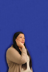 Adult 40-year-old Latina woman suffers pain in her teeth due to cavities and gingivitis, she...