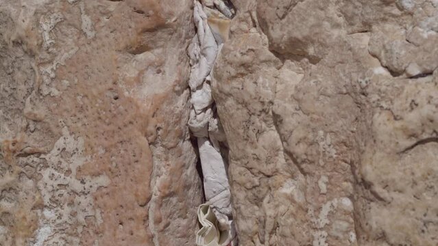 Praying Notes Tuck Into Stones Crevice at the Jerusalem Western Wall and Former Second Temple in Holy land. A famous pilgrimage site for Jews, Christians and Muslims.
