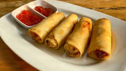 Deep Fried Spring Roll Served with tomato Sauce and chili sauce.