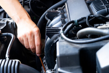 Car maintenance technician He is checking the auto engine, car inspection center.