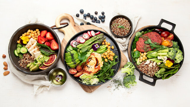 Healthy vegetarian and vegan  salads and Buddha Bowls with vitamins, antioxidants, protein on light  background.