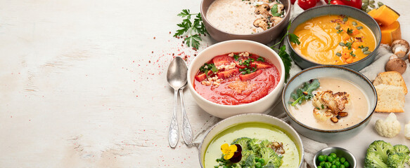 Composition with various soups, ingredients and space for text on white background. Healthy food.