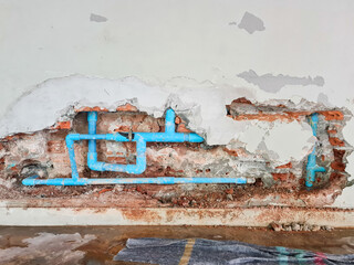 Repairing leaking bathroom plumbing systems by smash the concrete wall to open it for repair water...