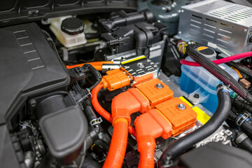 Orange connecting elements of a hybrid automobile engine with elements electronic distribution...