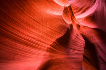 Playing the flaming wave of the underground labyrinth of the sand walls of Lower Antelope Canyon in...