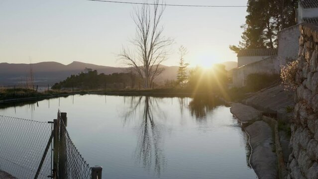 Reservoir at sunset with reflections in Barranc dels Molins Ibi, Alicante, Spain