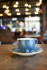 blue color coffee cup with a cafe background 