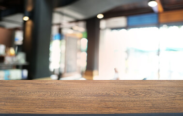 Empty dark wooden table in front of abstract blurred bokeh background of restaurant . can be used for display or montage your products.Mock up for space.