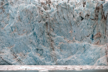 The massive face of the Surprise Glacier on Prince William Sound on a foggy and misty day seen from...