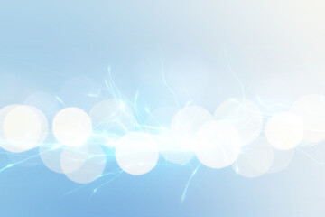 Abstract background of light blue shades with glare and bokeh effect.