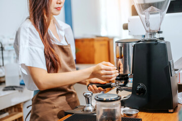 Barista hands coffee barista woman make hot cup espresso shot from coffee machine.