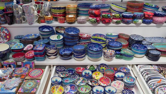 Display of hand-painted plates and porcelain souvenirs in the Central Market (Mercado Central) of Valencia, Spain.