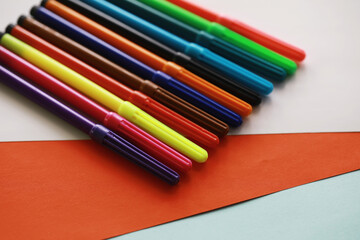 Colorful Crayons and flomasters on paper background stock photo