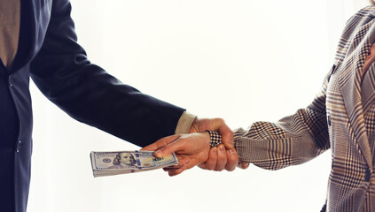 Woman Hand taking cash paper money from man hand.Banknote exchange.Paying woman for service or bribe.