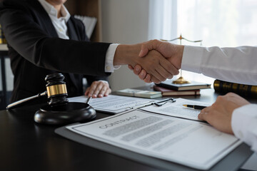 Lawyers shaking hands agreeing on a legal contract to sign a financial business venture contract...