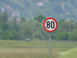 Selective focus shot of a Maximum Speed Limit 60 Street Sign with trees in the background