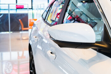 Side mirror on car of white modern car.