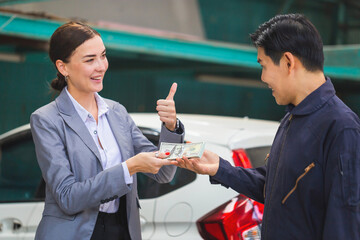 Customers paying mechanics with cash at the repair garage, Customer and mechanic in auto repair shops, Car repair and maintenance