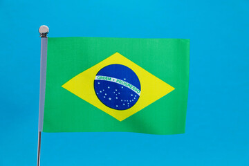 Brazilian flag waving on blue background