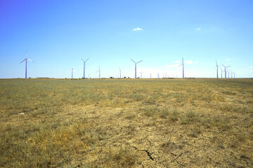 wind farm in the steppe against the blue sky