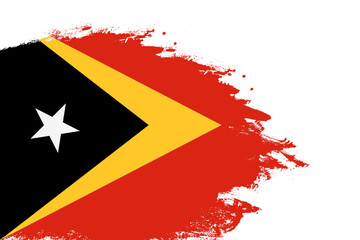 East Timor flag on a stained stroke brush painted isolated white background with copy space