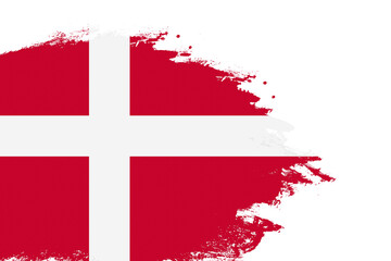 Denmark flag on a stained stroke brush painted isolated white background with copy space