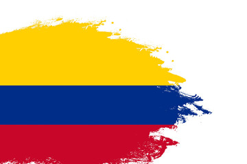 Colombia flag on a stained stroke brush painted isolated white background with copy space