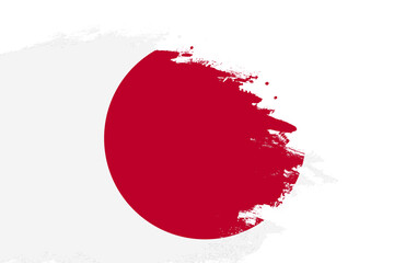 Japan flag on a stained stroke brush painted isolated white background with copy space