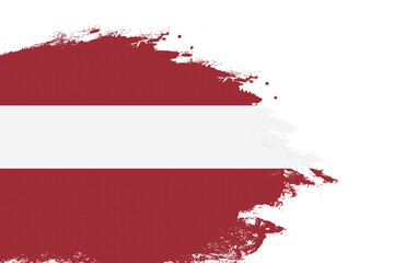 Latvia flag on a stained stroke brush painted isolated white background with copy space