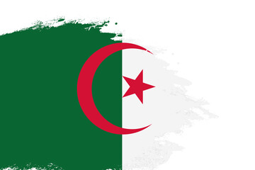 Algeria flag on a stained stroke brush painted isolated white background with copy space