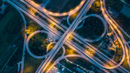 Aerial top view of highway and overpass in city at night, Aerial view of the traffic and intersection road at the city, Highway road junctions at night.