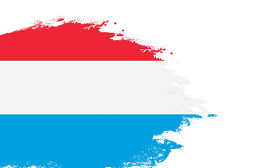 Luxembourg flag on a stained stroke brush painted isolated white background with copy space