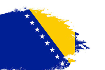 Bosnia And Herzegovina flag on a stained stroke brush painted isolated white background with copy space - obrazy, fototapety, plakaty