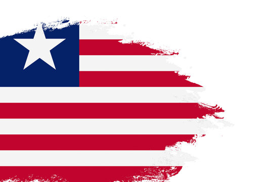 Liberia flag on a stained stroke brush painted isolated white background with copy space
