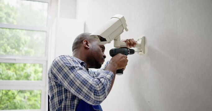 Close-up Of Technician Adjusting CCTV Camera
