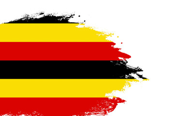 Uganda flag on a stained stroke brush painted isolated white background with copy space