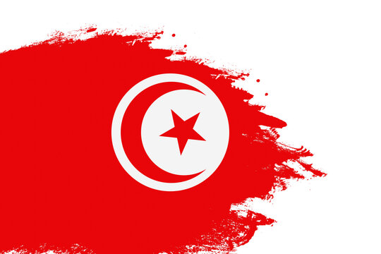 Tunisia flag on a stained stroke brush painted isolated white background with copy space