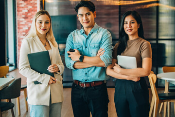 Shot of college students use laptops and tablets to complete homework and assignment. Socializing with friends in academic library. Self-discipline, practiced in positive and inspiring atmosphere