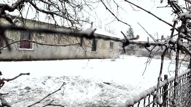 Old prison barracks in Siberia against background of barbed wire (out of focus)
