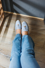 Slender female legs in jeans and blue loafers. Collection of summer women's shoes. Stylish women's...