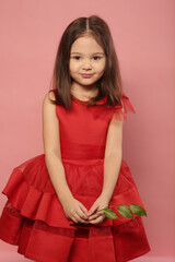 cute little girl in red dress happy closeup portrait on pink background