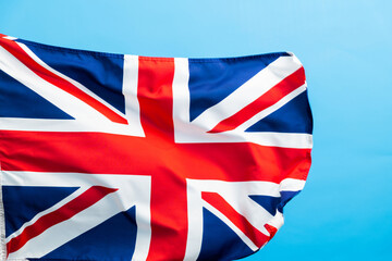 Fototapeta premium British flag waving on blue background