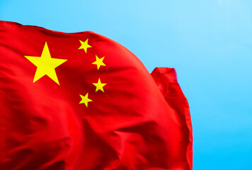 Chinese flag waving on blue background