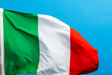 Italian flag waving on blue background
