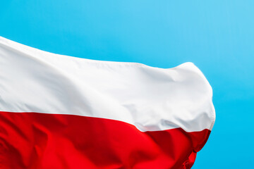Poland flag waving on blue background
