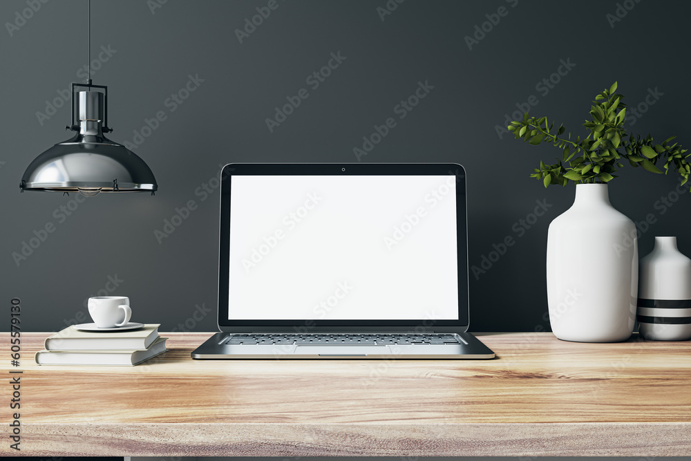 Poster Front view on blank whit modern laptop screen with space for your web design on wooden work table with vases and books on dark grey wall background with chrome lamp. 3D rendering, mock up
