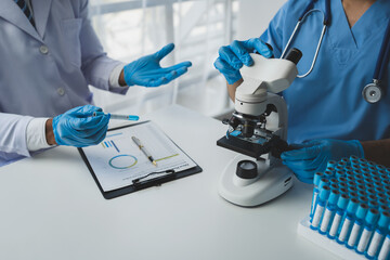 Scientist working with a microscope Laboratory team doing medical research Scientific test tubes in...