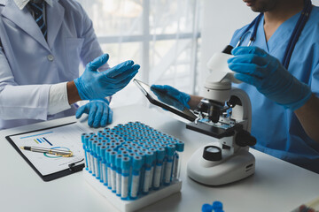 medical research laboratory Team of scientists or doctors using digital tablets analyzing advanced science lab data for medicine. biotechnology development of microbiology Research concept, insurance