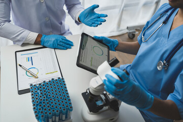 medical research laboratory Team of scientists or doctors using digital tablets analyzing advanced science lab data for medicine. biotechnology development of microbiology Research concept, insurance