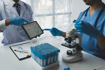 medical research laboratory Team of scientists or doctors using digital tablets analyzing advanced science lab data for medicine. biotechnology development of microbiology Research concept, insurance